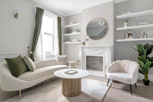 a living room with a couch and a table and a mirror at Kerridge Terrace - Old World Inner city Charm in Sydney