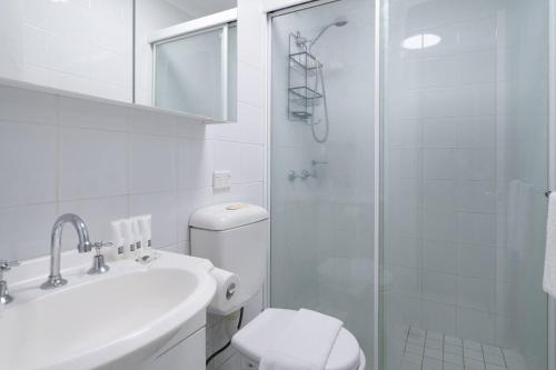 a bathroom with a shower and a toilet and a sink at Bronte Haven - Coastal Bliss for Families in Sydney