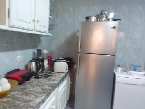 uma cozinha com um frigorífico de aço inoxidável em Appartement centre ville em Larache