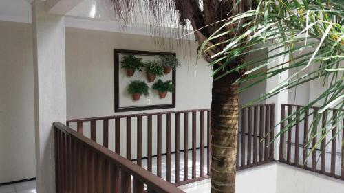 a hallway with a staircase with plants on the wall at Hotel Praia 2000 in Fortaleza