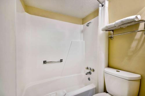 a white bathroom with a toilet and a shower at Motel 6 Effingham, IL in Effingham