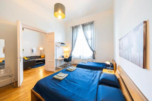 a bedroom with a blue bed in a room at Shining bright two bedroom apt next to Andrassy ave in Budapest