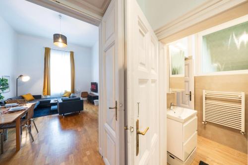 a living room with a table and a dining room at Shining bright two bedroom apt next to Andrassy ave in Budapest