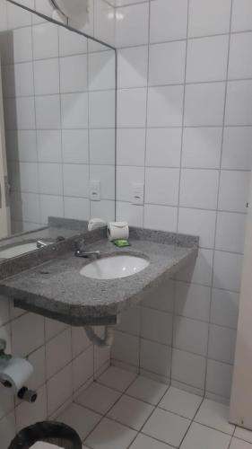a bathroom with a sink and a mirror at Hotel Praia 2000 in Fortaleza