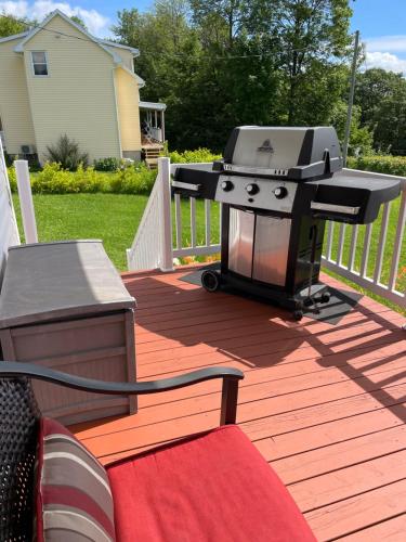 a grill on the deck of a house at Chalets Plage St-Jean 2 in Saint-Jean