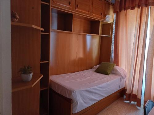 a small bedroom with a small bed in a closet at Apartamento Grande Subida San Diego Centro Ciudad in Cartagena