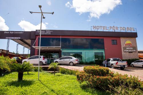 a parking lot with cars parked in front of a building at Pôr do Sol Hotel in Santarém