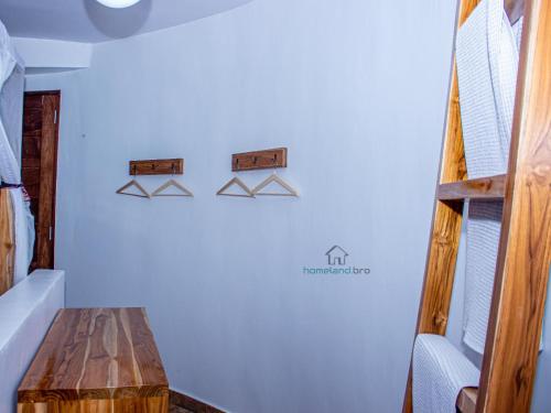 a room with a wooden table and shelves on the wall at homeland bro in Dar es Salaam