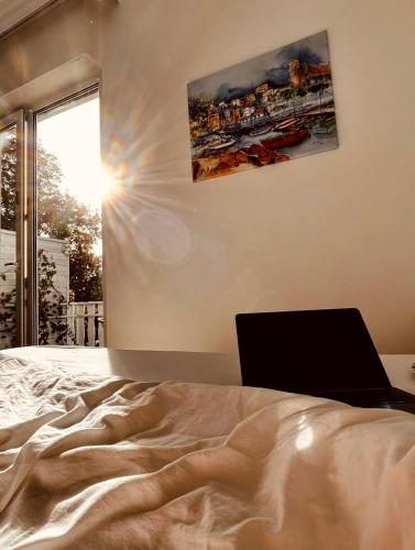a bedroom with a bed with a laptop on it at Strand Studio mit Meerblick & Balkon in Lübeck