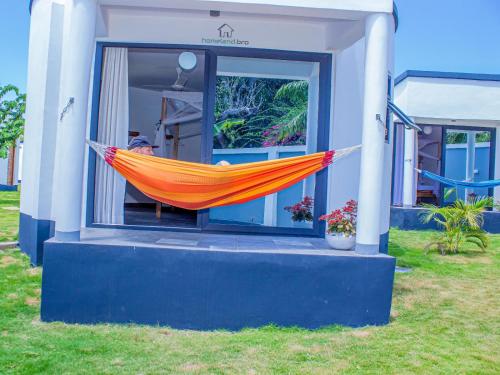an orange hammock on the side of a house at homeland bro in Dar es Salaam