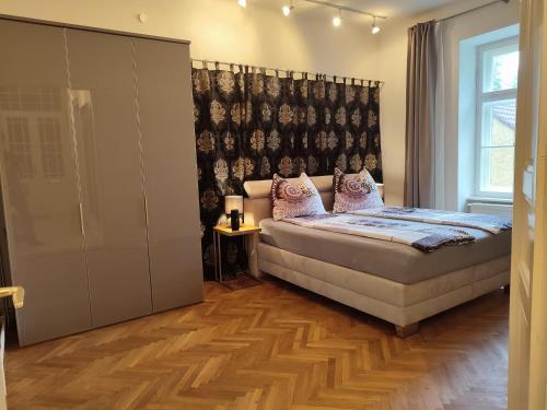 a bedroom with a bed and a large window at Bookstyrian1 in Graz
