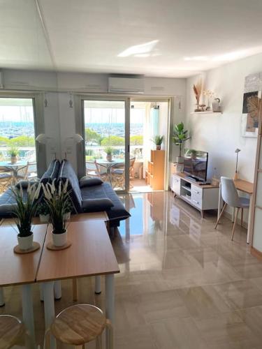 a living room with a couch and a table at STUDIO-PORT-MARINA, Parking privé, climatisé au "DUCAL" in Villeneuve-Loubet