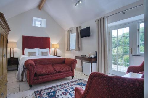 a bedroom with a bed and a chair and window at Brynach - 1 Bedroom - St Ishmaels in Saint Ishmaels