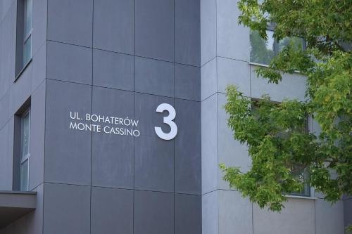 a building with a sign on the side of it at Apartamenty Centrum in Białystok