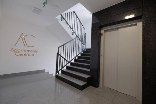 a staircase in an office building with a door at Apartamenty Centrum in Białystok