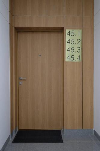 a door with a clock on the side of it at Apartamenty Centrum in Białystok