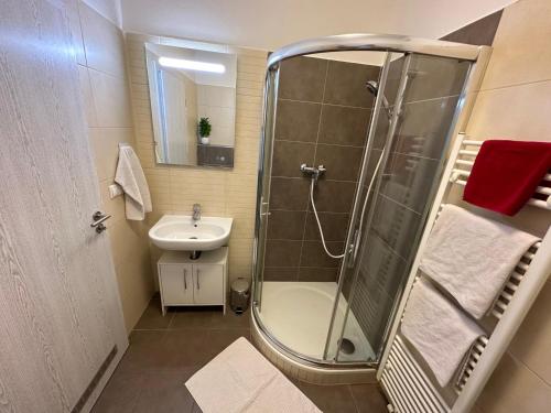 a bathroom with a shower and a sink at Studio Ostrava - Penthouse Karolina in Moravská Ostrava