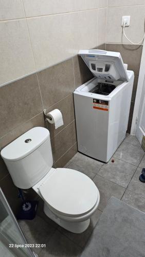 a bathroom with a toilet and a sink at Puerto Rico Top Teide and Amadores View in Puerto Rico de Gran Canaria