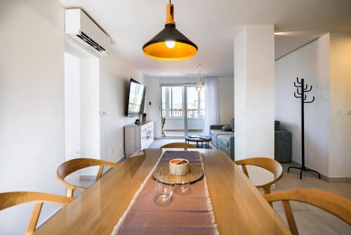 a dining room and living room with a table and chairs at Penthouse with view in city center in Split