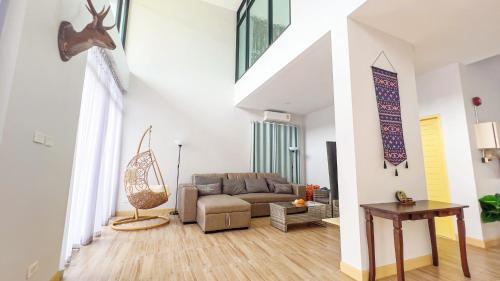 a living room with a couch and a table at Aonang nine poolvilla in Ao Nang Beach