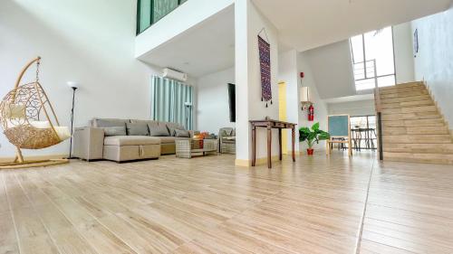 a large living room with a couch and a staircase at Aonang nine poolvilla in Ao Nang Beach
