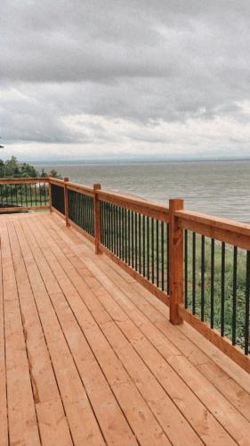 a wooden deck with a view of the ocean at Le Crustacé 2 a 4 personnes in Nouvelle