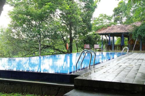 a swimming pool with aicrobialicrobialicrobialicrobialicrobial at Lake Serenity Resort & Spa in Kuruwita