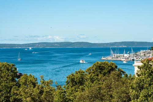 a view of a large body of water with boats at Penthouse with view in city center in Split