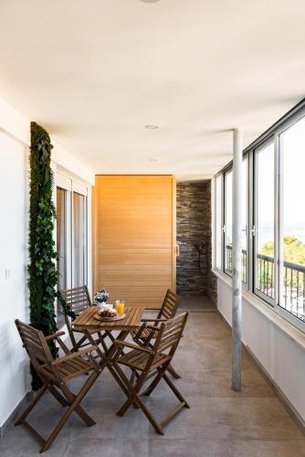 a dining room with a table and chairs on a balcony at Penthouse with view in city center in Split