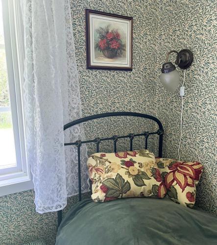 a bedroom with a bed with a pillow on it at Stuga i Vomb in Veberöd