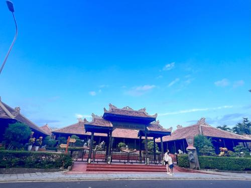 a person walking in front of a building at I Play Inn NT in Nha Trang