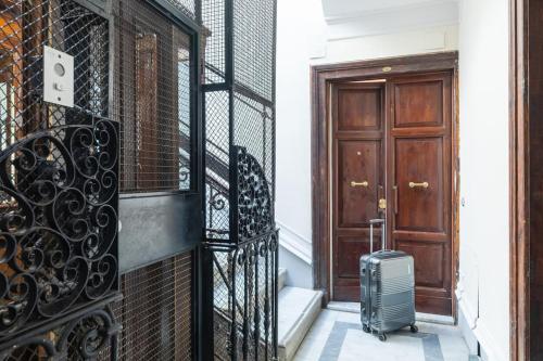 a suitcase is sitting on the steps next to a door at Domus Quirinale in Rome