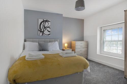 a bedroom with a large bed and a window at Stylish Comfort 2-BedFlat In Stockton, Sleeps 3 in Stockton-on-Tees