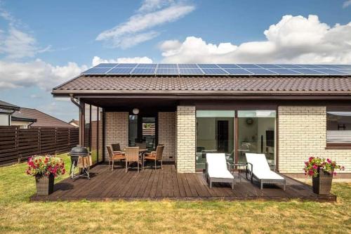 a house with a deck with a solar panel on it at VoVoHouse in Ginduliai
