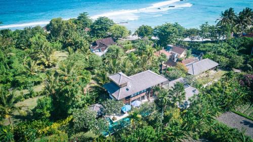 an aerial view of a house on the beach at Villa Rumah Isah in Candidasa
