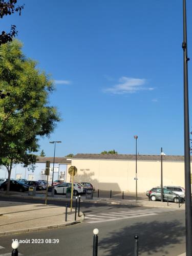 a parking lot with cars parked in front of a building at KYRIAD ORANGE Centre Ville - HOTEL & RESTAURANT & BAR - La Galerie d'Art des Princes - Provence Alpes Côte d'Azur - France - Proche A7-A9 - exit21- Châteauneuf-du-Pape Avignon Bollene Nimes - 24h-24h in Orange