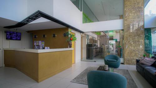 a lobby with a counter and chairs in a building at Flat Completo Prox Manaíra Shopping e Praia in João Pessoa