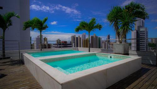 a swimming pool on the roof of a building at Flat Completo Prox Manaíra Shopping e Praia in João Pessoa