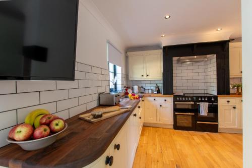 una cocina con un bol de fruta en una barra en Northern Hideaways Ellingham, en Chathill