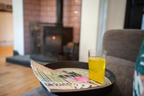 a glass of orange juice sitting on a table at Northern Hideaways Ellingham in Chathill