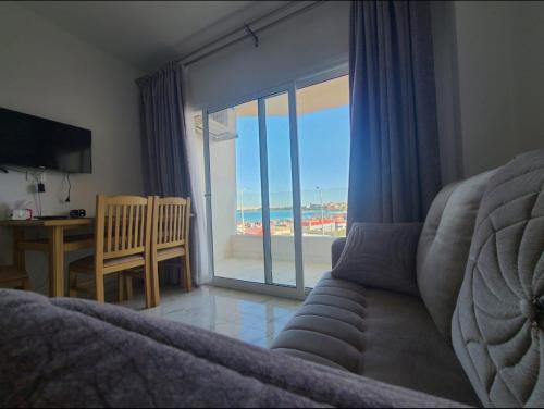 a living room with a couch and a view of the ocean at Hurghada Pearl in Hurghada