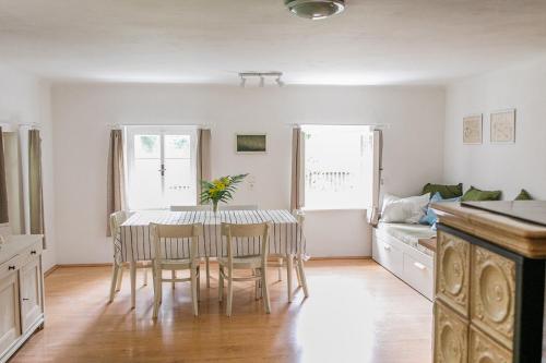 a kitchen and dining room with a table and chairs at Chaloupka v Českém Ráji in Semily