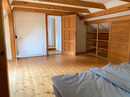 an empty room with a bed and a closet at Chaloupka v Českém Ráji in Semily