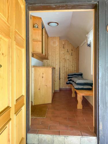 a room with wooden walls and a room with a table at Chaloupka v Českém Ráji in Semily