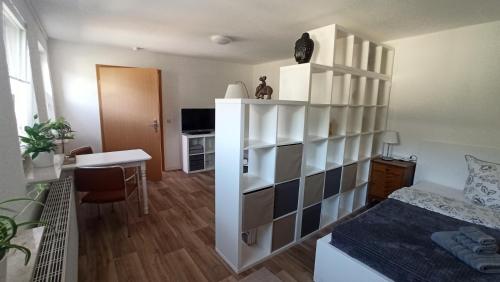 a bedroom with a large white shelving unit at Finki's Ferienwohnungen 