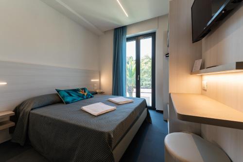 Postel nebo postele na pokoji v ubytování Hotel La Bussola