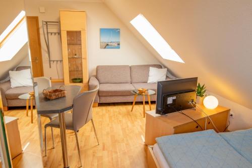 a living room with a couch and a tv at Holiday Home Blu Hus in Freest
