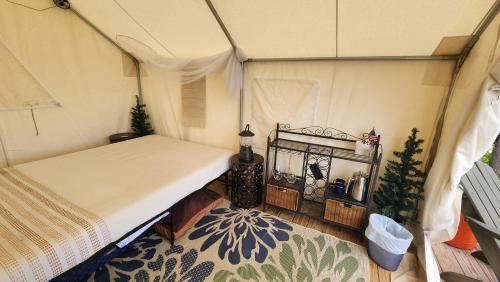 a bedroom with a bed in a tent at Tentrr Signature Site - Mountain View in Buckfield Maine in Paris