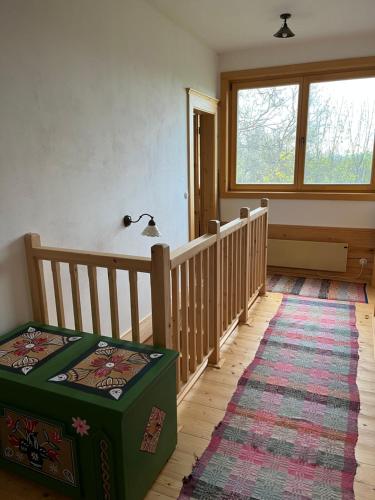 a room with a stairway with a green ottoman at Chalupa u Golisov in Zákopčie