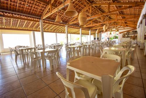 uma fila de mesas e cadeiras num restaurante em Hotel Fazenda M1 em Águas de Lindoia
